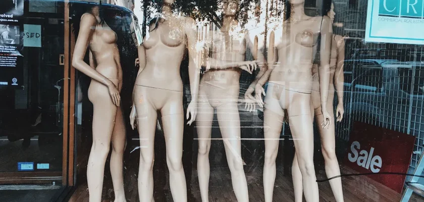 Realistic full-body mannequin in storefront