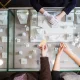 Locking glass jewelry display case with rings and necklaces on a retail store counter